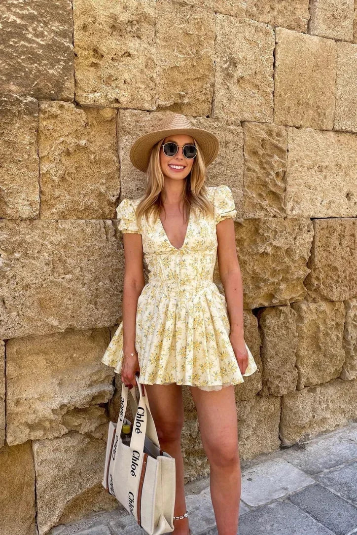 Yellow floral mini dress with tied back summer garden