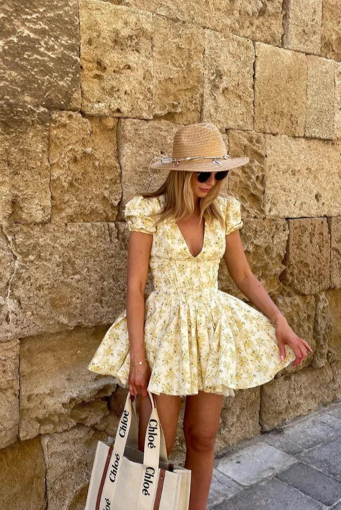 Yellow floral mini dress with tied back summer garden