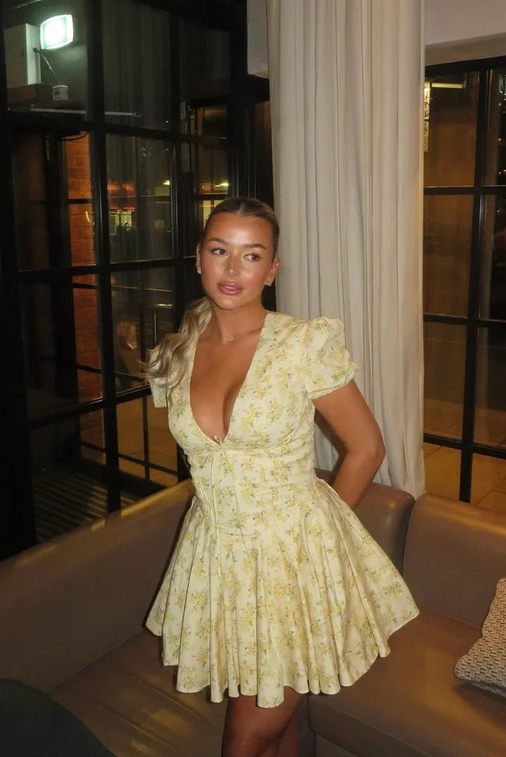 Yellow floral mini dress with tied back summer garden