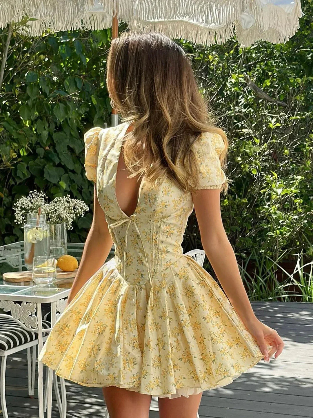 Yellow floral mini dress with tied back summer garden